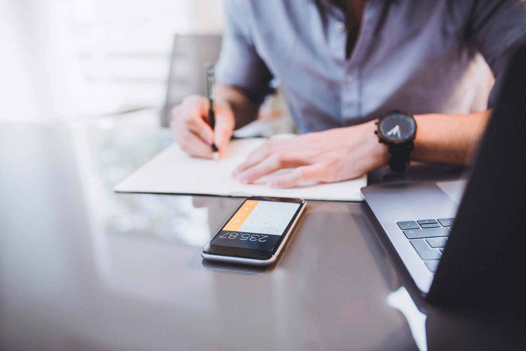 Man performing tax or home buying calculations on his phone