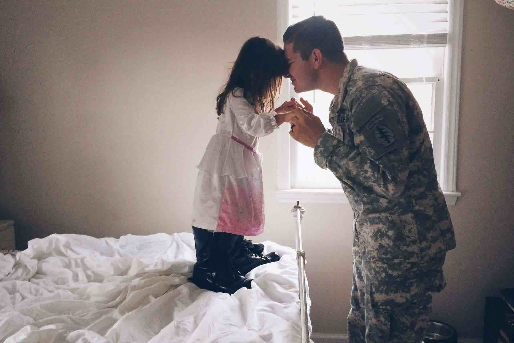 Young military father with his daughter showing affection