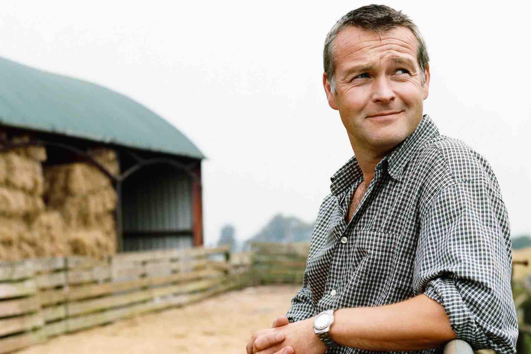Farmer Leaning on a Gate in a Paddock