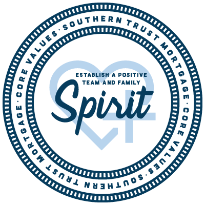 Blue and white circular badge with a heart symbol and the text “Spirit”.