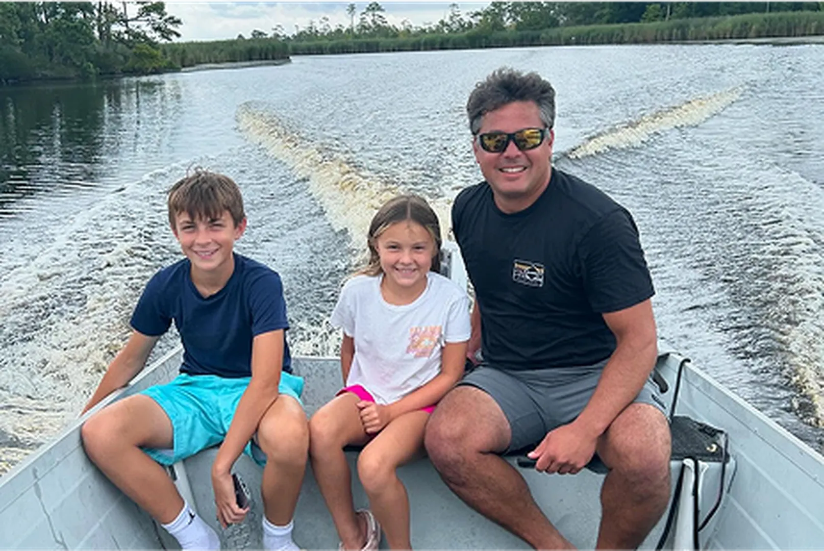 Brandon Beddie, Mortgage Loan Officer, with his children on a boat.