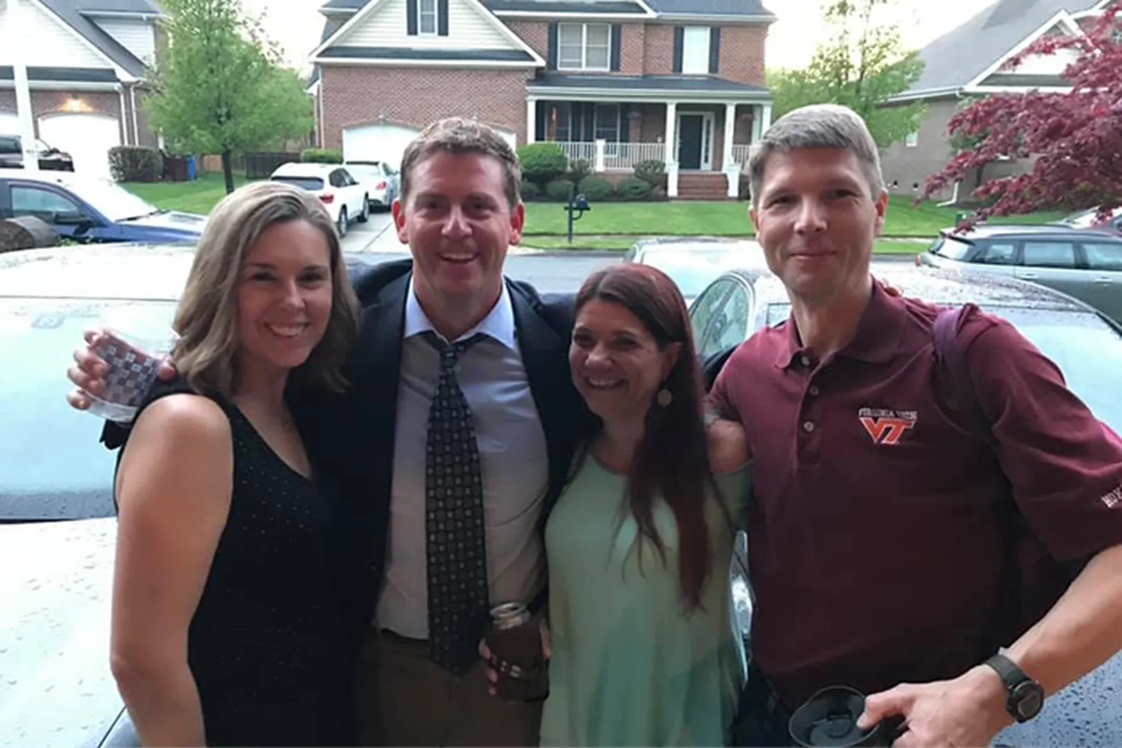 Brandon Blalock, Mortgage Loan Officer, posing with his family in front of a residential home.