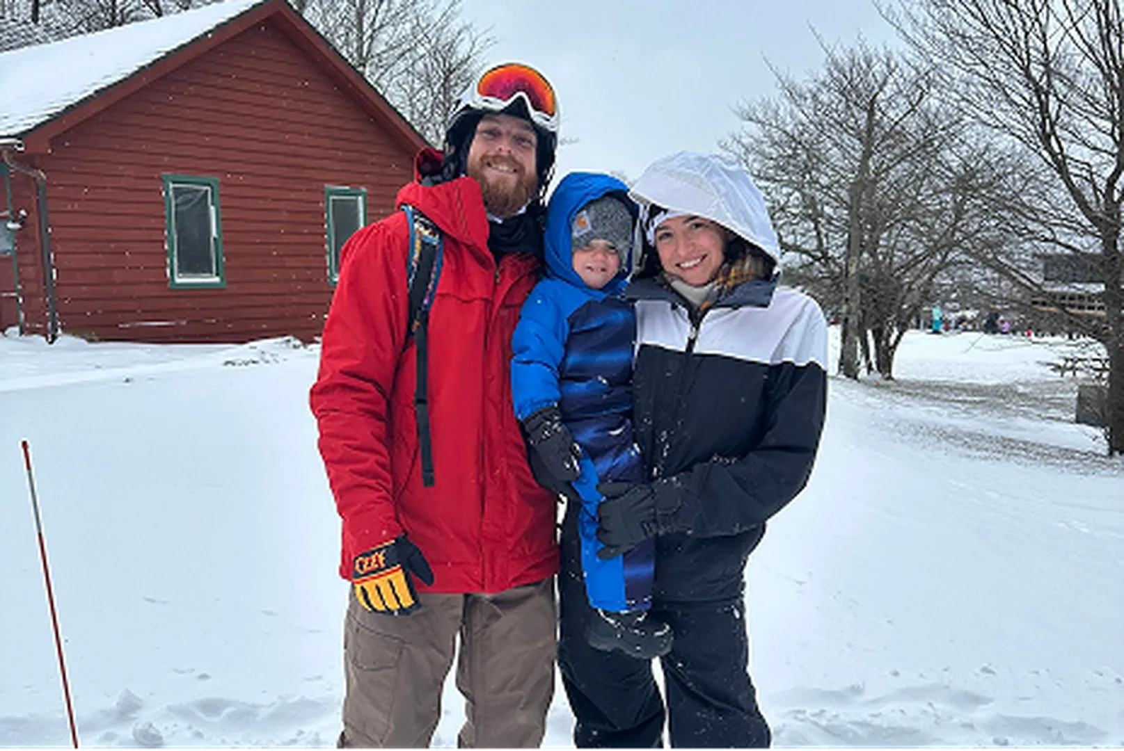Brandon Reilly, Mortgage Loan Officer, pictured in snow with his wife and children.
