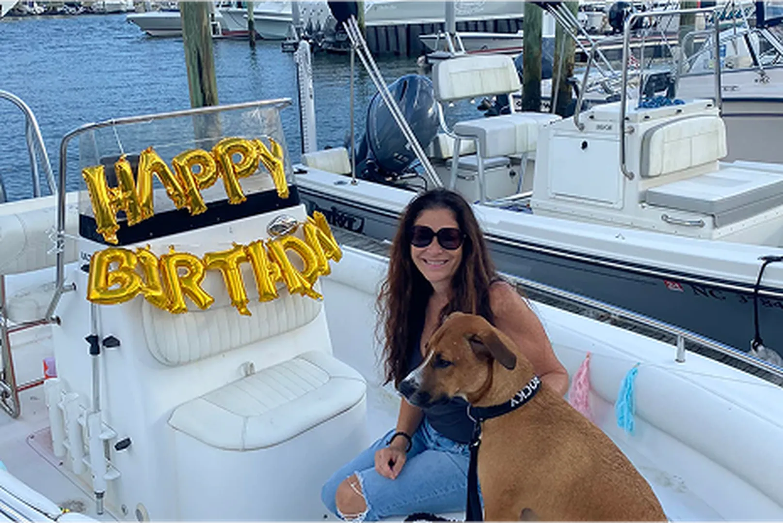 Kelly Barnes, Mortgage Loan Officer, enjoying a boat ride with her dog.