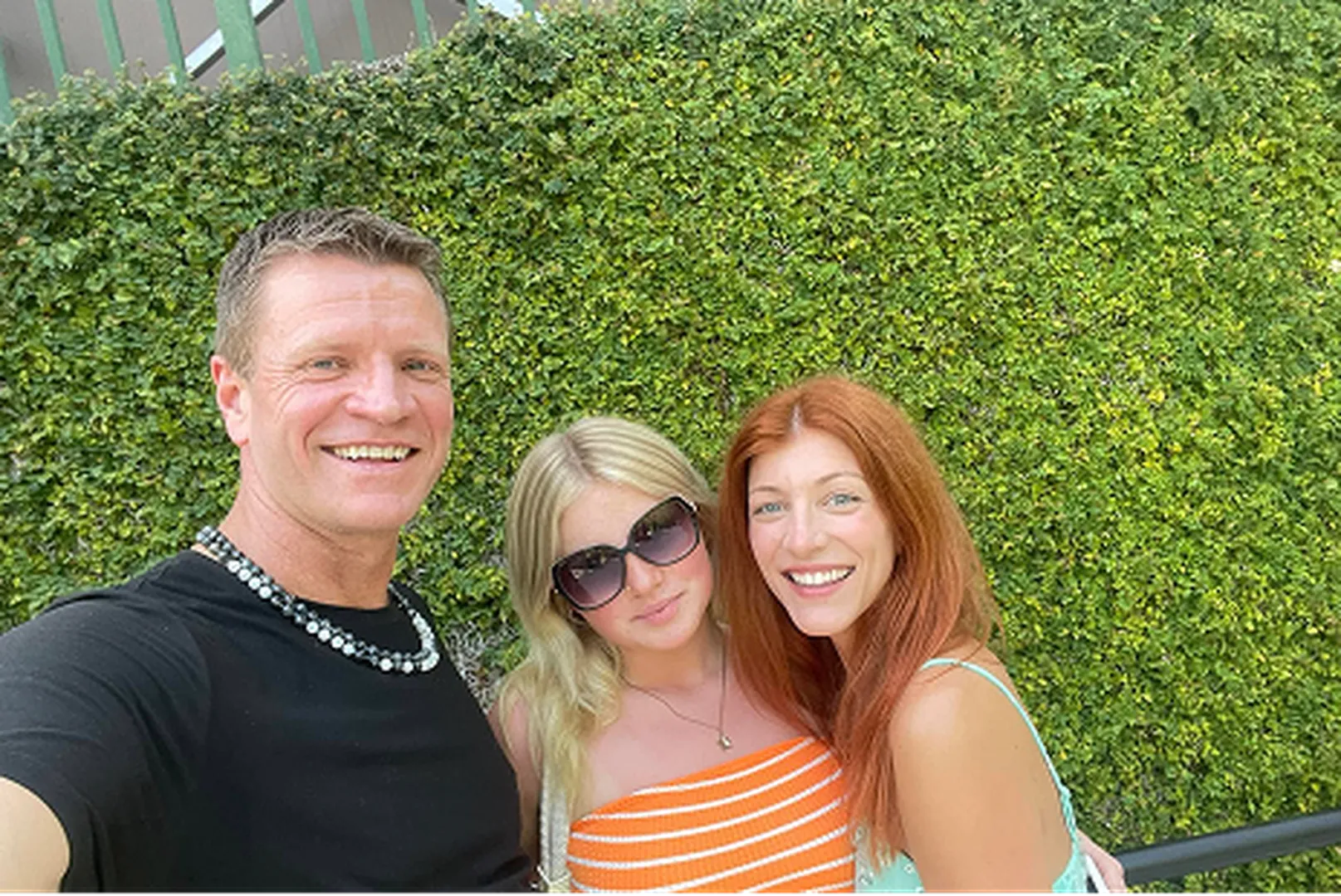 Kris Dumas, Mortgage Loan Officer, with his family, posing outdoors.