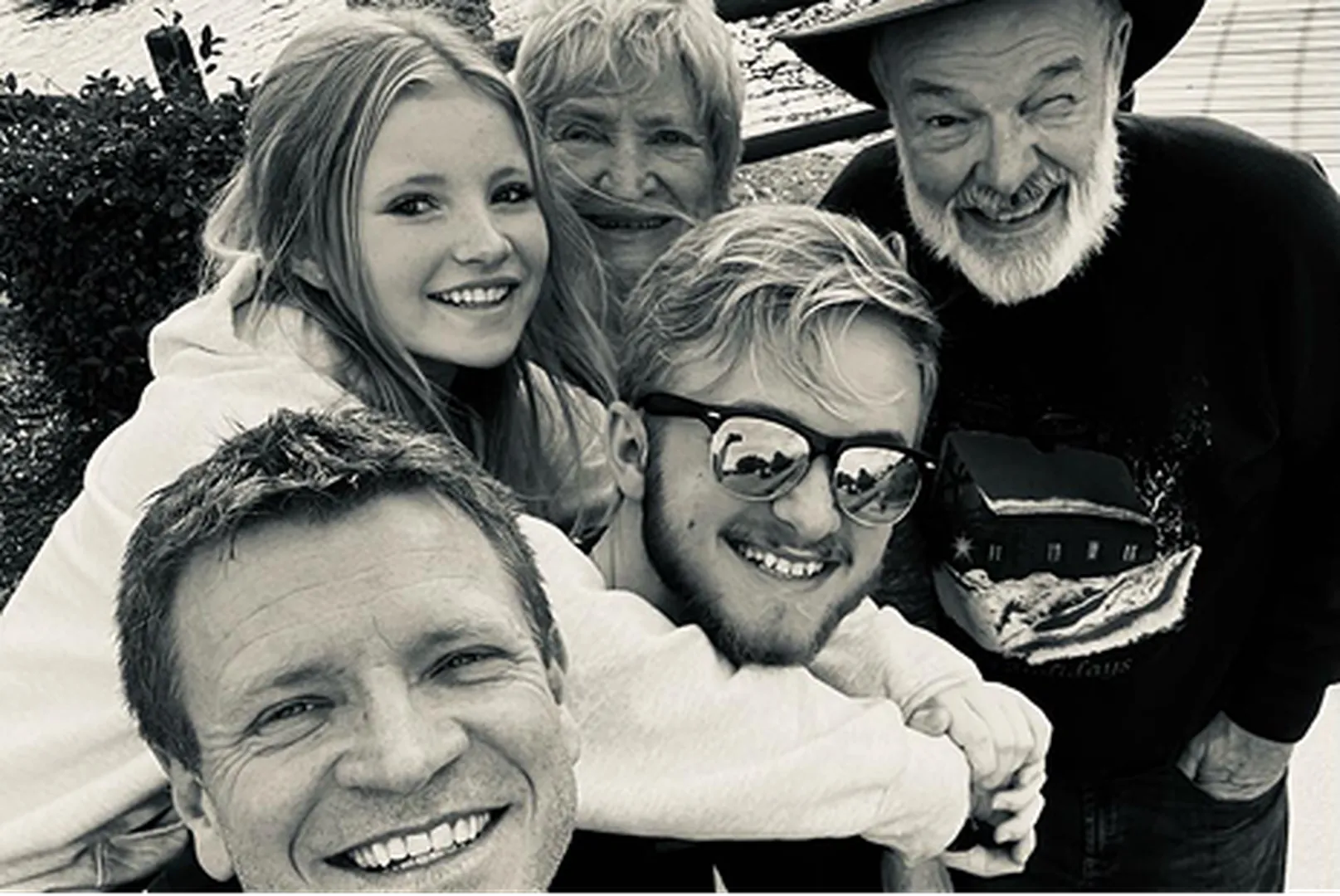 Kris Dumas, Mortgage Loan Officer, with a group of people in a black and white photograph.