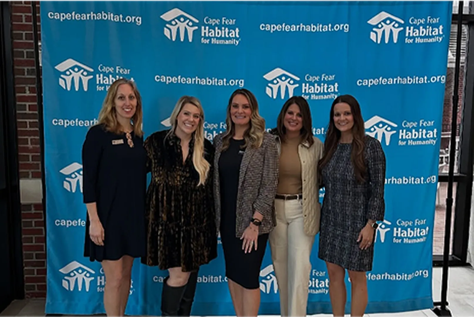 Ryann McLean, Mortgage Loan Officer, pictured standing with other women.